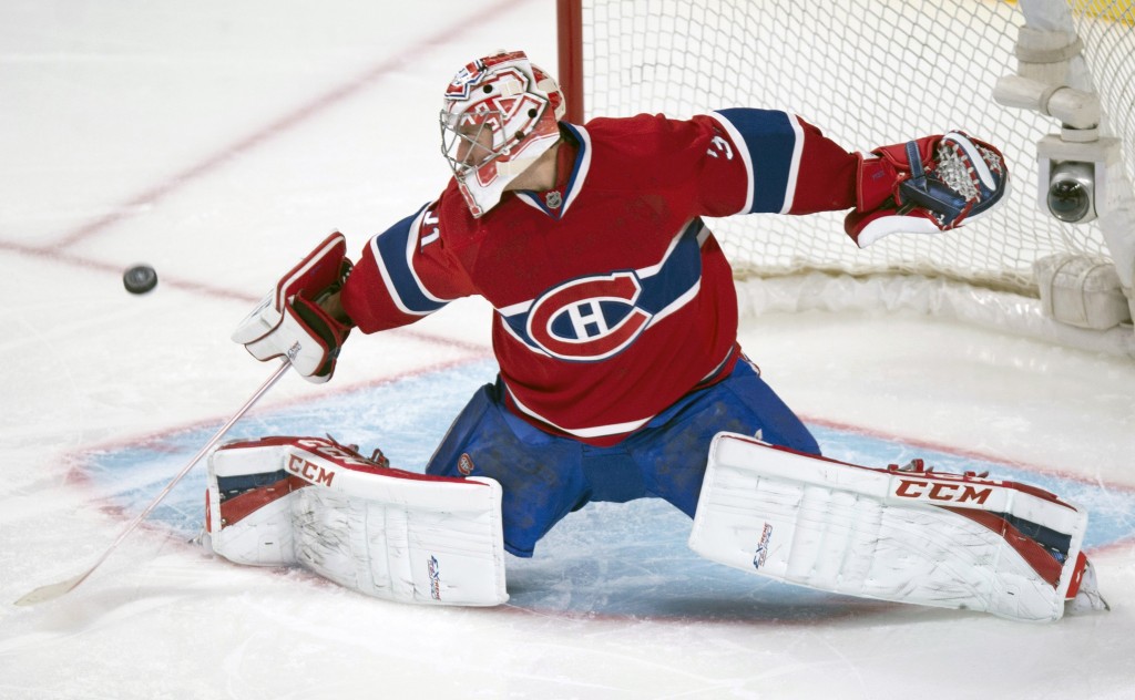 Montreal Canadiens goalie Carey Price deflects a shot during first period of an NHL hockey game against the New York Islanders, Sunday, Nov. 10, 2013, in Montreal. (AP Photo/The Canadian Press, Paul Chiasson)